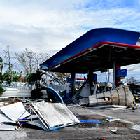 A gas station that has been torn apart by hurricane. Photo by Carl Kho on Unsplash