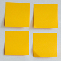 Four post-it notes on a wall. Original photo by Nathan Dumlao on Unsplash