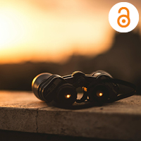 Close-up of black binoculars with sunset colors in the backgound. Photo by Ran Berkovich on Unsplash