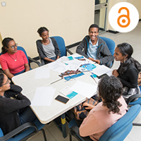 People around a table discussing. Photo by Maheder Haileselassie Tadese/Getty Images/Images of Empowerment