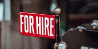 Red "For hire" sign. Photo by Clem Onojeghuo on Unsplash