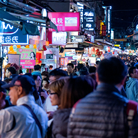 people walking on street during night time, photo by David Emrich on Unsplash